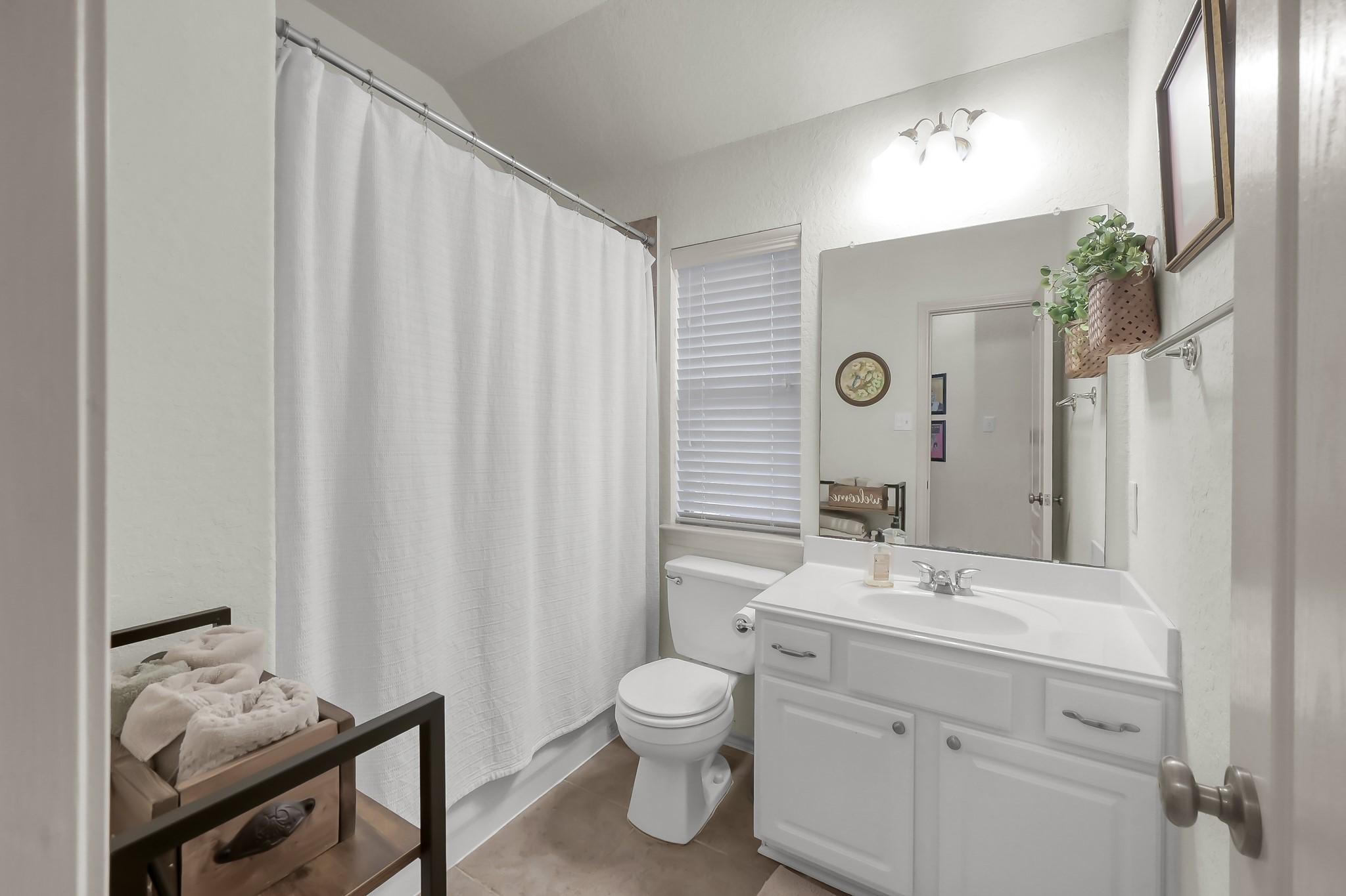 2318 Caroline Park Lane Spring, TX 77386 - Photo 31 of 38 a bathroom with a toilet sink and mirror