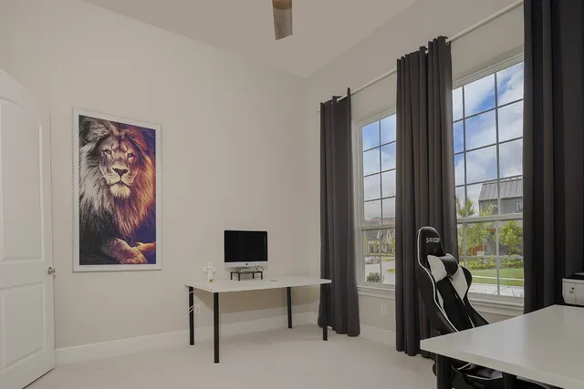 a view of a workspace with furniture and a window