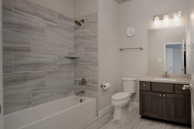 a bedroom with a large bed and a dresser