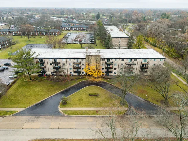 an aerial view of residential houses with outdoor space and swimming pool