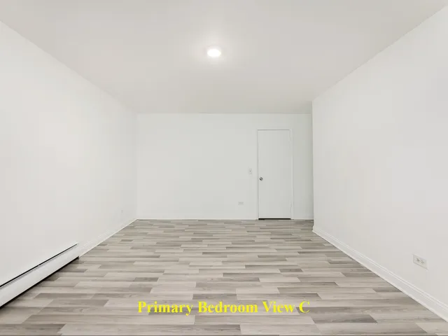 a view of an empty room and wooden floor