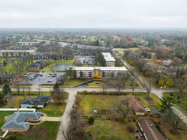 an aerial view of residential houses with outdoor space