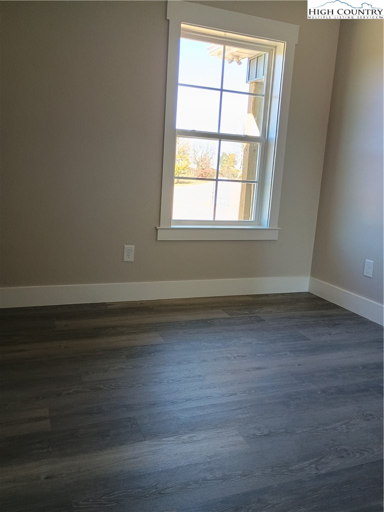 90 Millards Way Sparta, NC 28675 - Photo 5 of 8 an empty room with wooden floor and windows