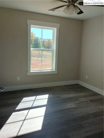 a view of wooden floor and windows in a room