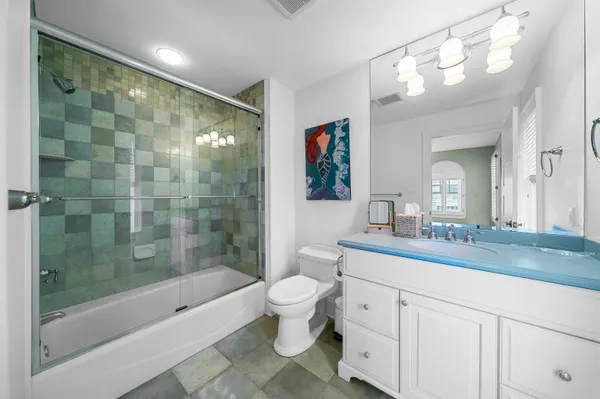 a bathroom with a double vanity sink toilet and shower