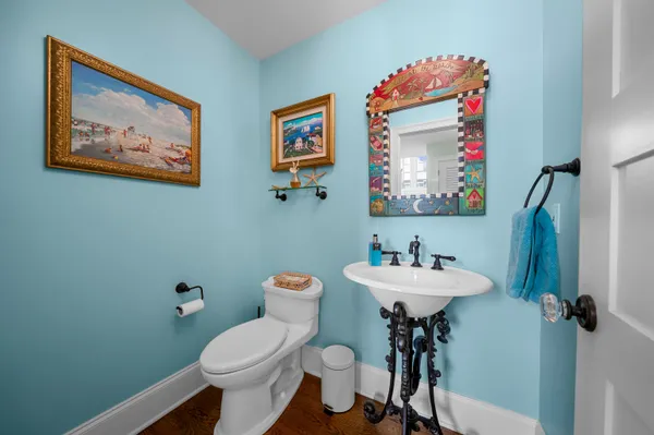 a bathroom with a toilet a sink and mirror