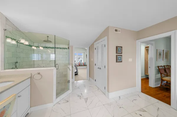 a bathroom with a shower and a sink