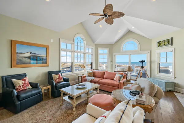 a living room with furniture a chandelier and a window