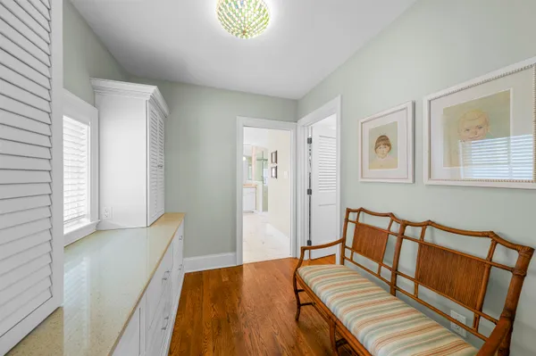 a bedroom with furniture and wooden floor