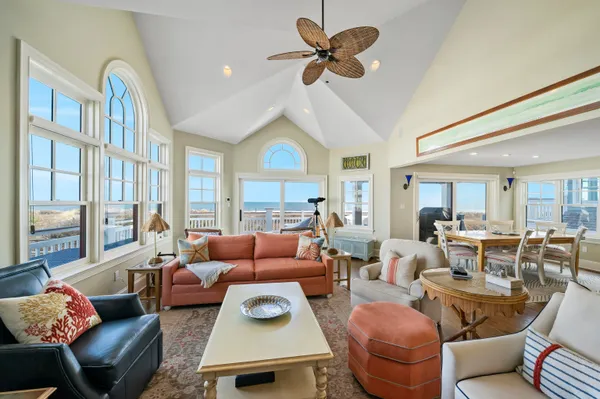 a living room with furniture a fireplace and a large window