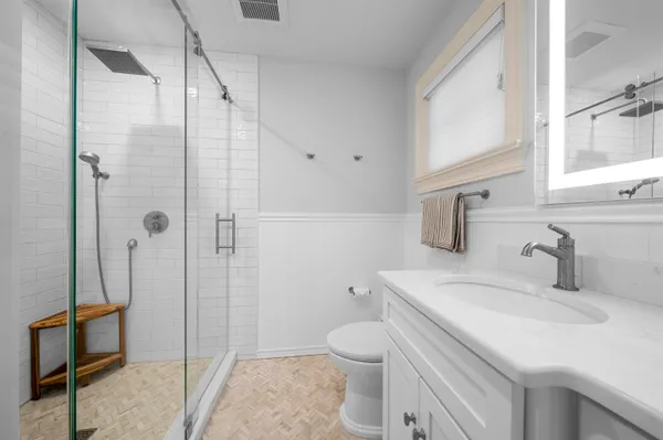 a bathroom with a sink toilet and shower