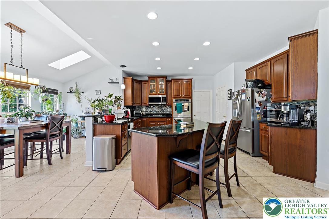 130 Lower Way Road Easton, PA 18045 - Photo 10 of 56 a dining hall with stainless steel appliances a dining table and chairs with the view of kitchen