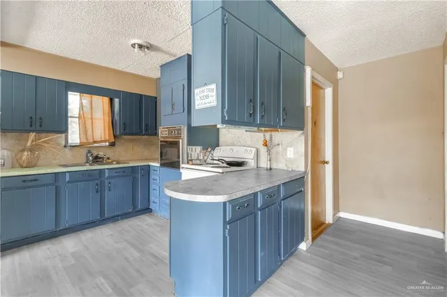 a kitchen with a sink stove and cabinets