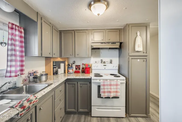 a utility room with stainless steel appliances cabinets and a sink
