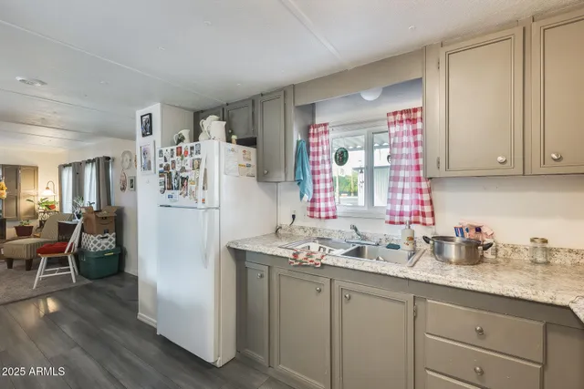 a kitchen with stainless steel appliances granite countertop a refrigerator and sink