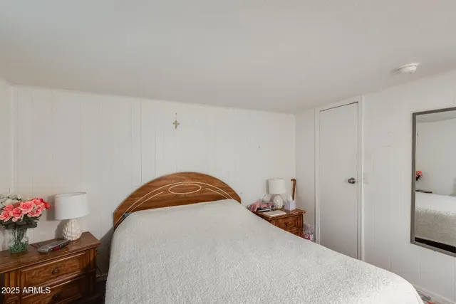 a bedroom with a bed and a potted plant