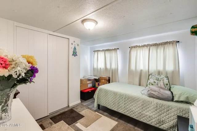 a bedroom with a bed and a potted plant