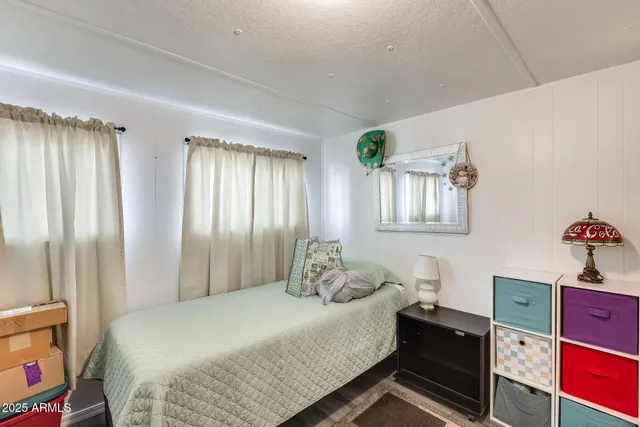 a bedroom with a bed and window