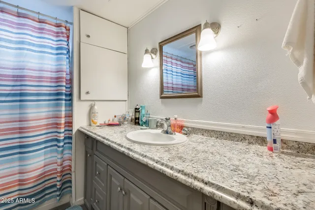 a bathroom with a sink and a mirror