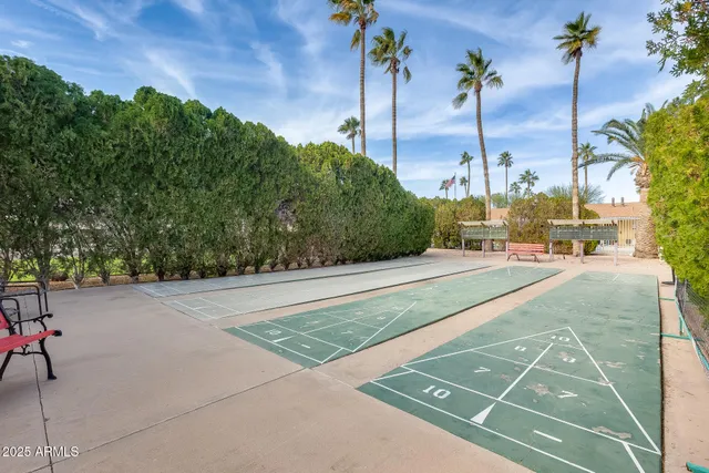 a backyard of a house with table and chairs
