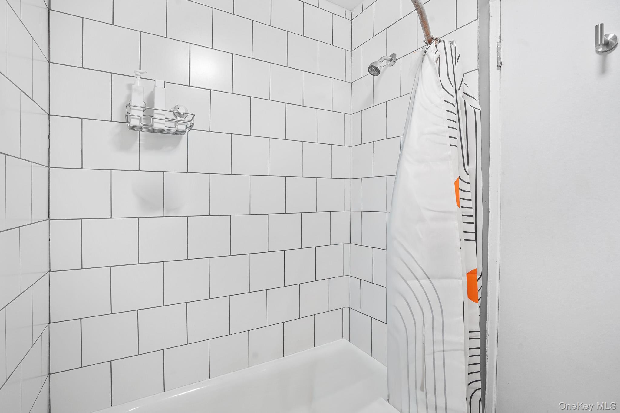 26 Cooper Road, Unit 411 Poughkeepsie, NY 12603 - Photo 14 of 17 Full bathroom featuring shower / bathtub combination with curtain