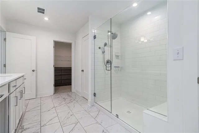 a bathroom with a shower and a sink