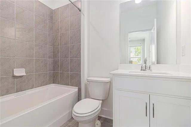 a bathroom with a sink a toilet and bathtub