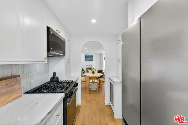 a kitchen with a sink and a stove top oven