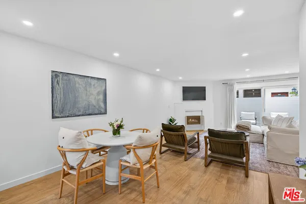 a living room with furniture a wooden floor and a flat screen tv