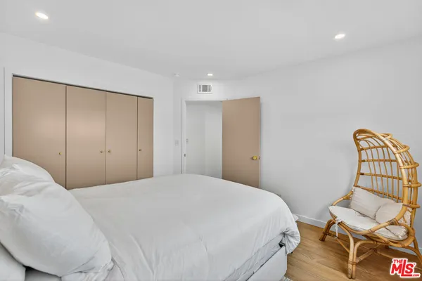 a bedroom with a bed and chair
