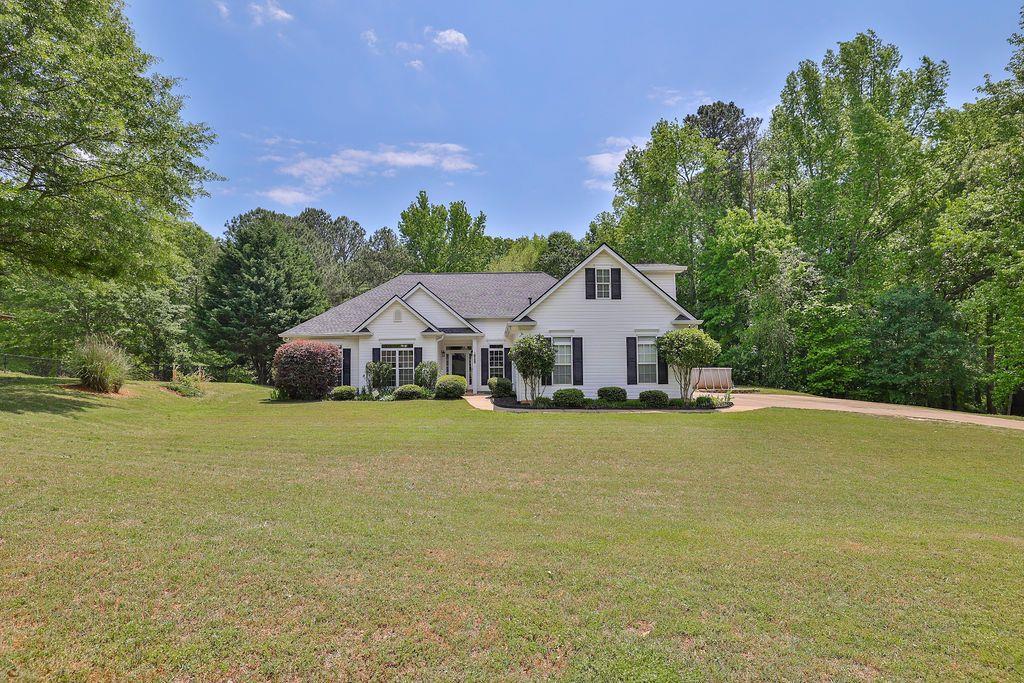 1471 Prospect Church Road Lawrenceville, GA 30043 - Photo 1 of 1 a front view of a house with a garden