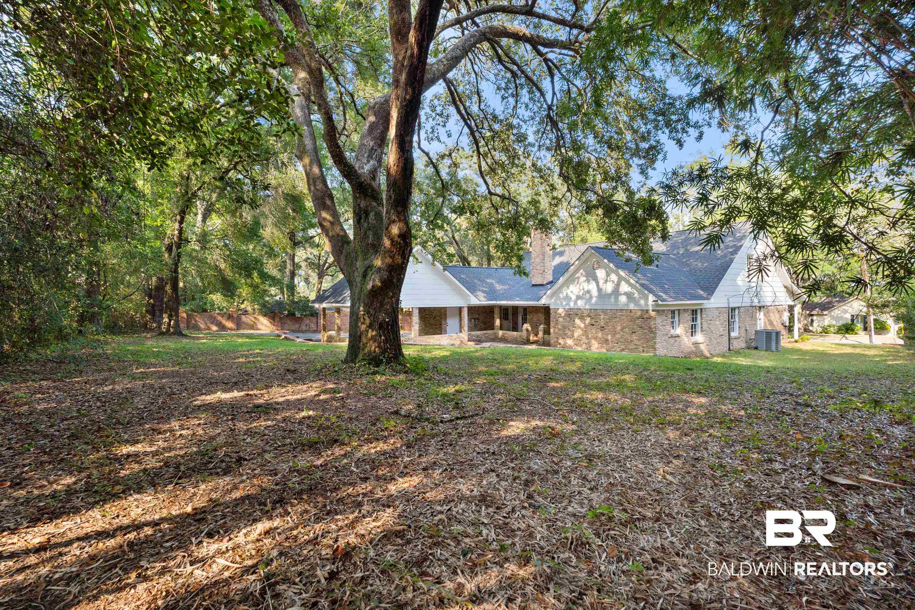 728 Spring Station Road Mobile, AL 36609 - Photo 27 of 35 View of front facade with brick siding, a chimney, and a front lawn