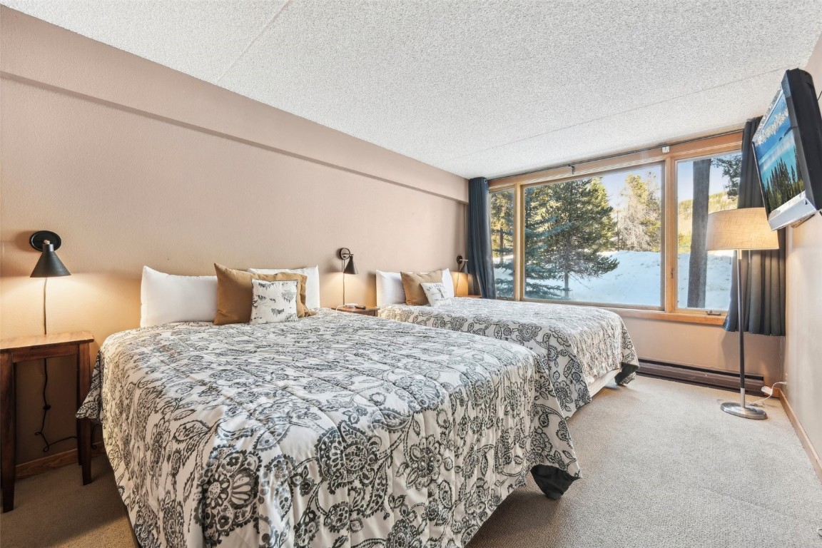 22340 Highway 6, Unit 1788 Keystone, CO 80435 - Photo 15 of 21 a bedroom with a bed and large windows