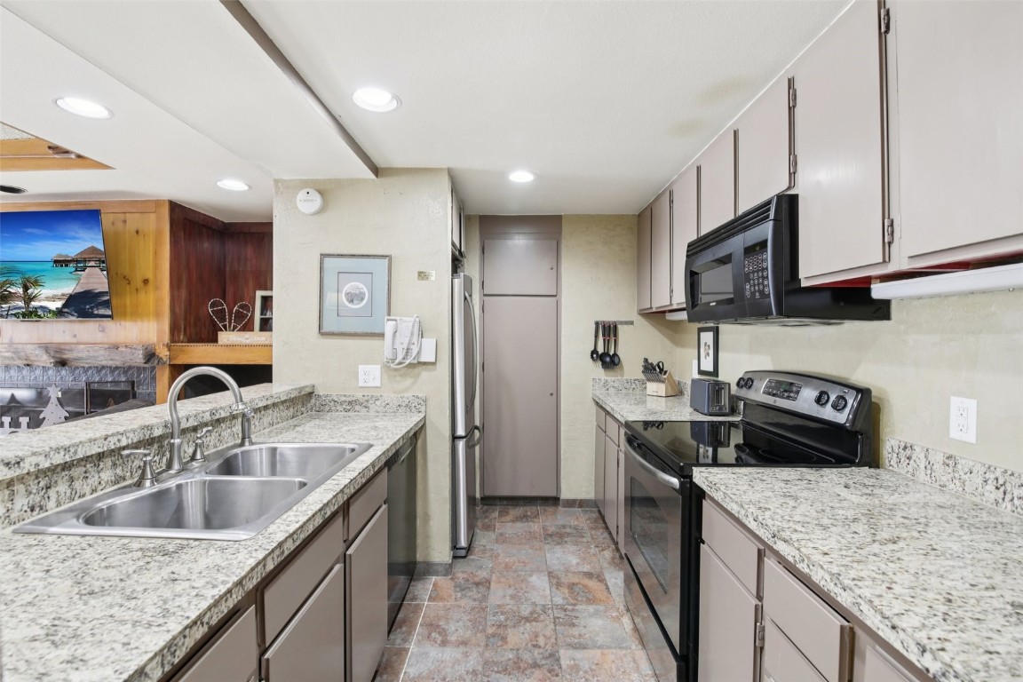 22340 Highway 6, Unit 1788 Keystone, CO 80435 - Photo 8 of 21 a kitchen with stainless steel appliances granite countertop a sink a stove and a refrigerator