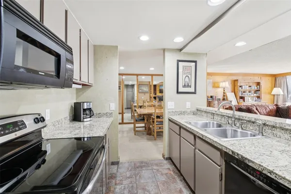 a kitchen with stainless steel appliances granite countertop a stove and a sink