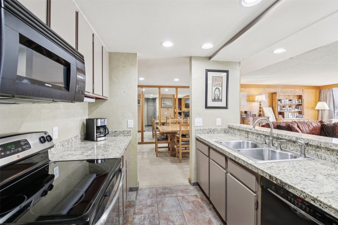 22340 Highway 6, Unit 1788 Keystone, CO 80435 - Photo 9 of 21 a kitchen with stainless steel appliances granite countertop a stove and a sink