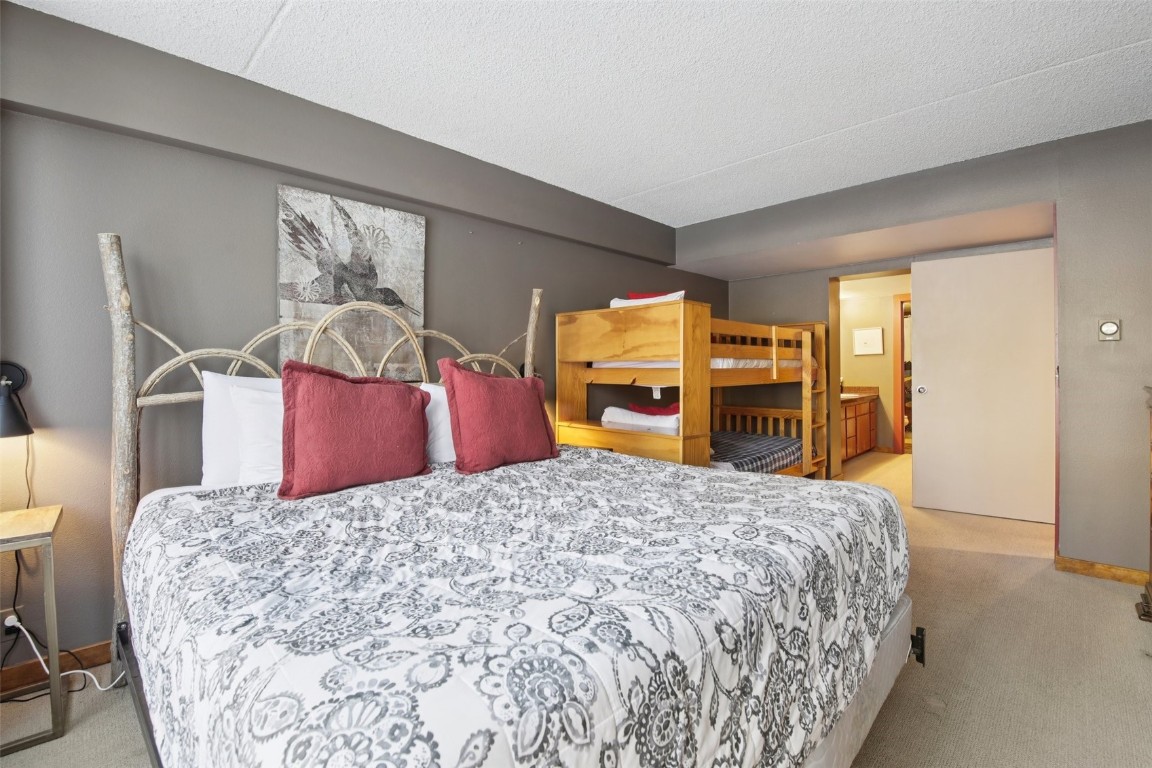 22340 Highway 6, Unit 1788 Keystone, CO 80435 - Photo 10 of 21 a bedroom with a large bed and a dresser