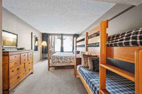 a bedroom with furniture and a flat screen tv