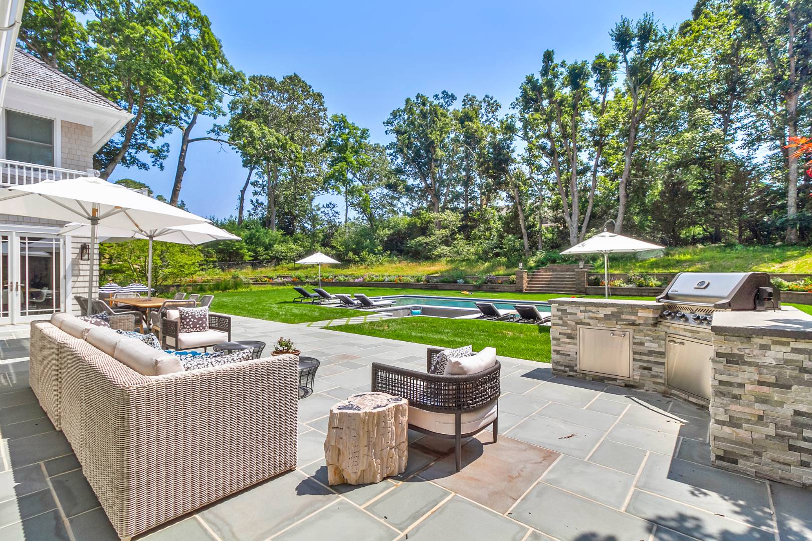 8 Shady Pth Bridgehampton, NY 11963 - Photo 3 of 30 a view of a patio with couches chairs and a fire pit