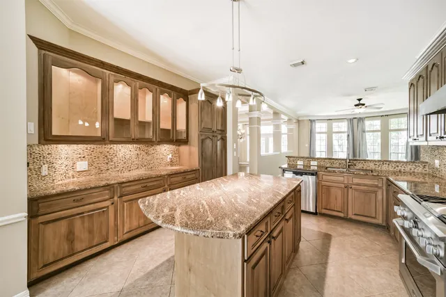 a kitchen with stainless steel appliances granite countertop a stove and a sink