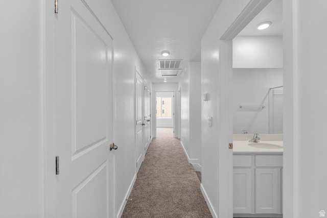 2133 Wolverine Way, Unit 2440 Washington, UT 84780 - Photo 16 of 39 Hallway featuring carpet flooring, crisp white walls, recessed lighting, and white paneled doors