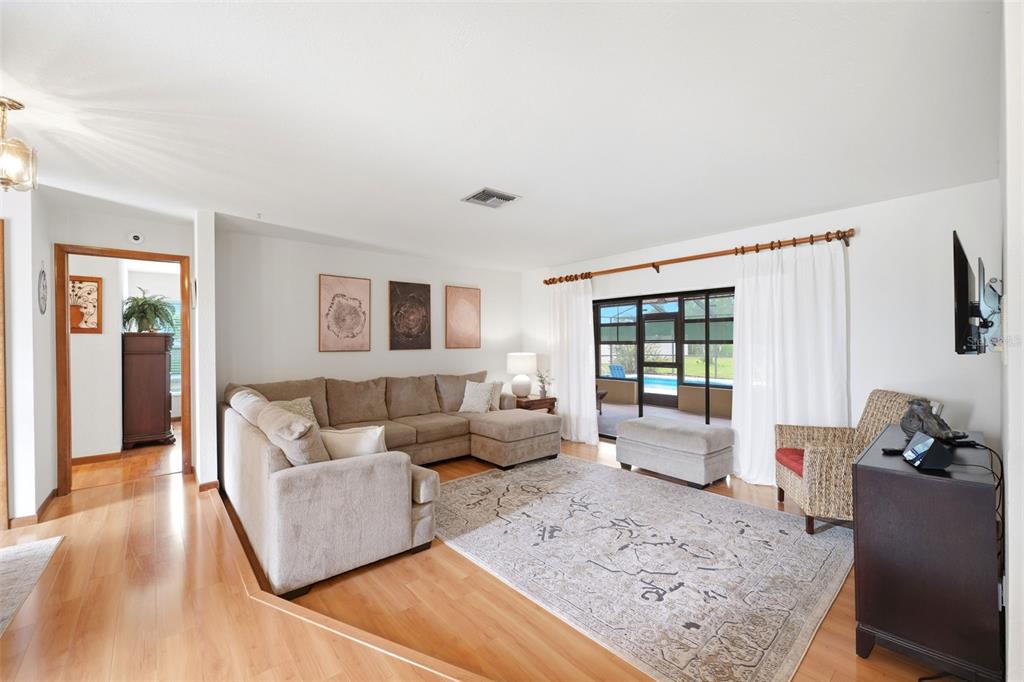 5227 Suwannee Road Weeki Wachee, FL 34607 - Photo 7 of 62 a living room with furniture and a large window