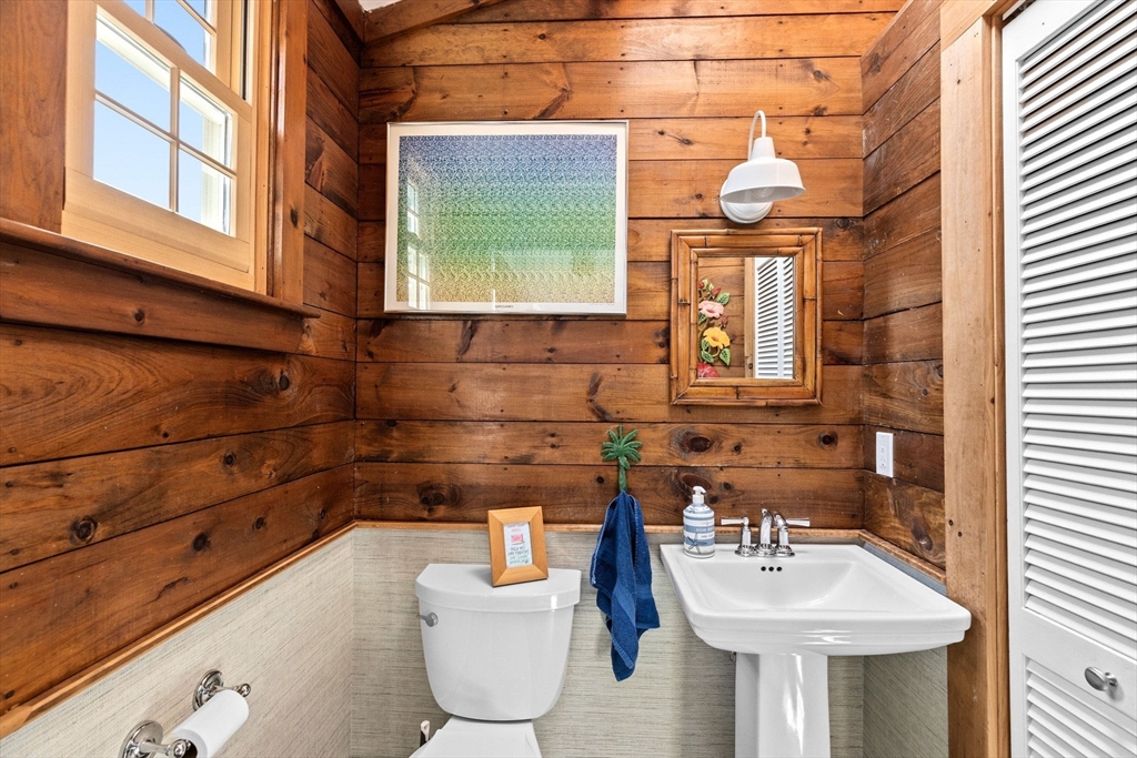 59 Gannett Road Scituate, MA 02066 - Photo 14 of 40 a bathroom with a toilet sink and mirror