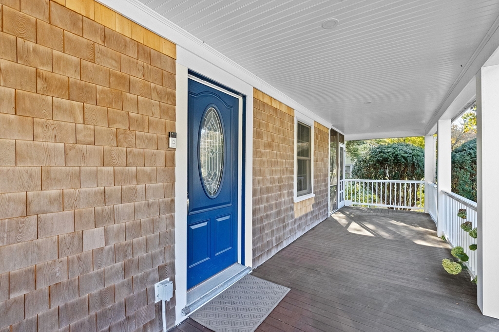 59 Gannett Road Scituate, MA 02066 - Photo 32 of 40 a view of a porch with a floor to ceiling window