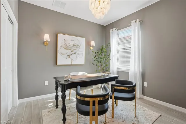 a view of a dining room with furniture and window