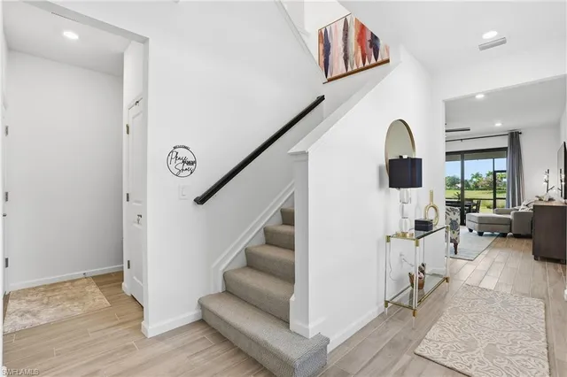 a view of entryway and hall with wooden floor