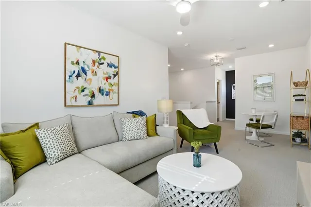 a living room with furniture and a mirror