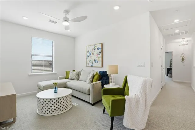 a living room with furniture a rug and a window
