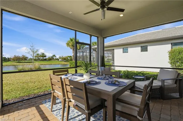 a view of an outdoor dining space with furniture and yard