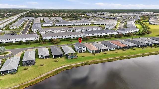 an aerial view of a city with swimming pool and lake view